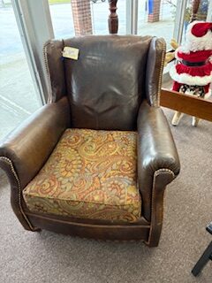 Distressed brown leather chair with nailheads
