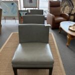 three vinyl armless chairs